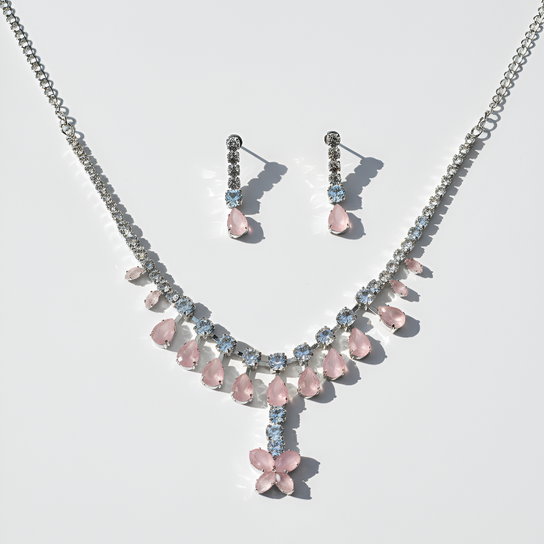 Jewelry set with pink and blue stones on a light gray background