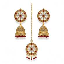 Gold and red gemstone earrings on a white background