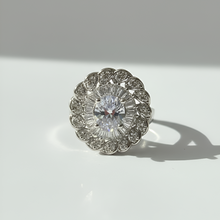 Diamond ring with intricate design on a white background