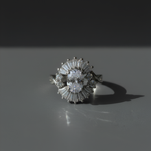 Diamond ring on a reflective surface with a dark background