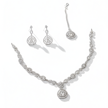 Silver necklace and earrings set on a white background