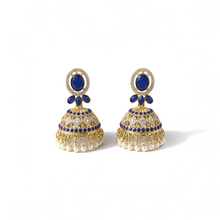 Pair of gold and blue earrings on a white background