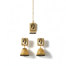 Gold earrings with intricate designs on a white background
