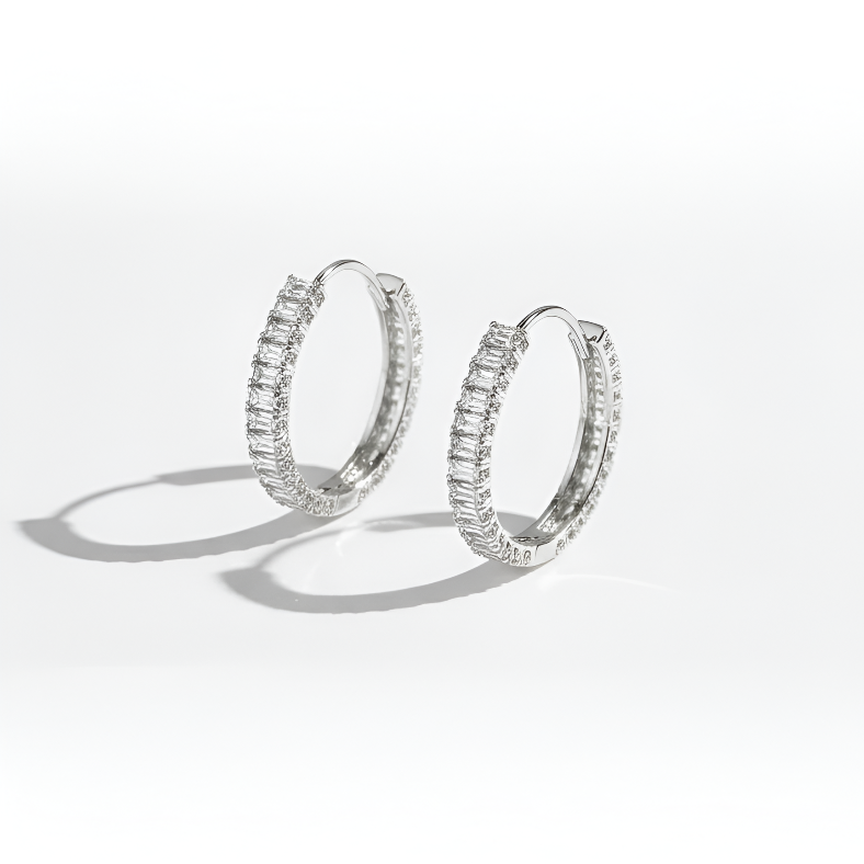 Pair of silver hoop earrings on a white background
