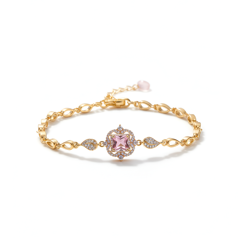 Gold bracelet with a pink gemstone on a white background