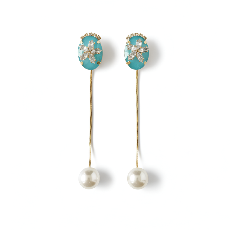 Pair of earrings with turquoise gemstones and pearl drops on a white background