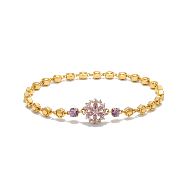 Gold bracelet with a snowflake charm on a white background
